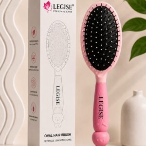 Pink oval brush close-up showing ball-tip bristles on cushioned base