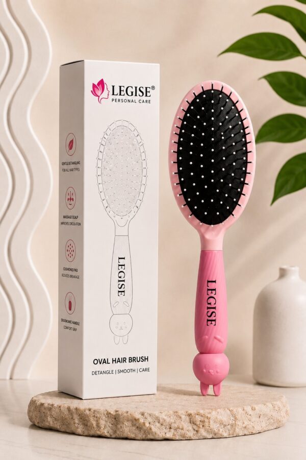 Pink oval brush close-up showing ball-tip bristles on cushioned base